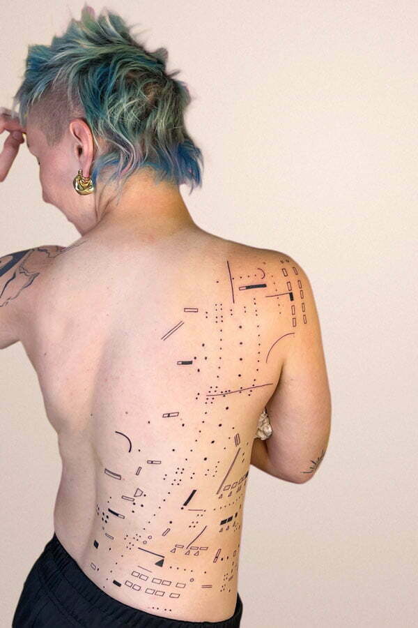 big back tattoo with dots and graphic elements inspired by bridge architecture in tokyo