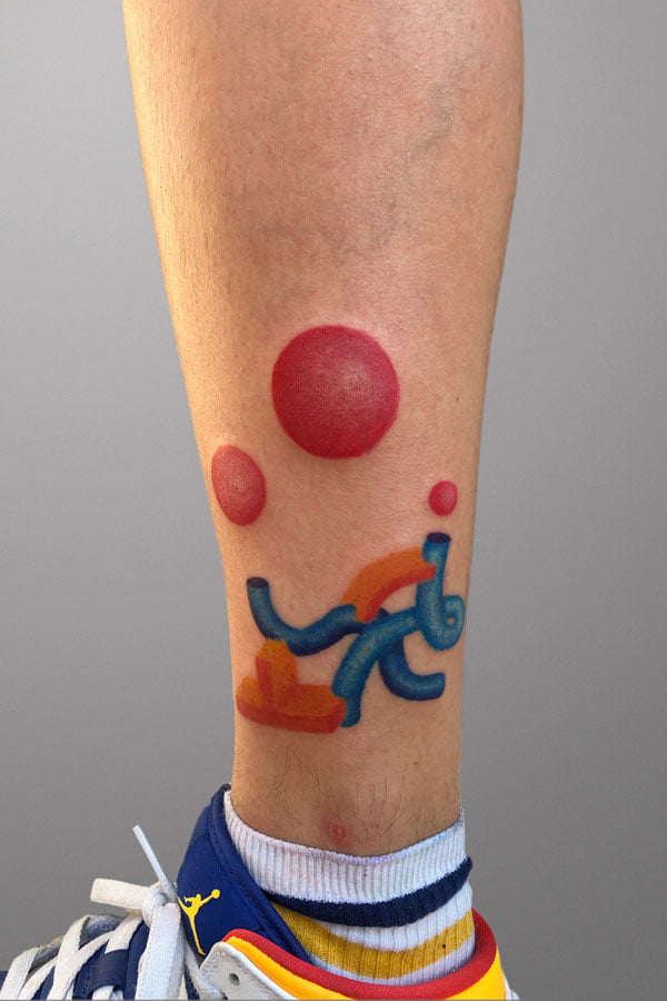 abstract colorful 3d shapes inked on ankle