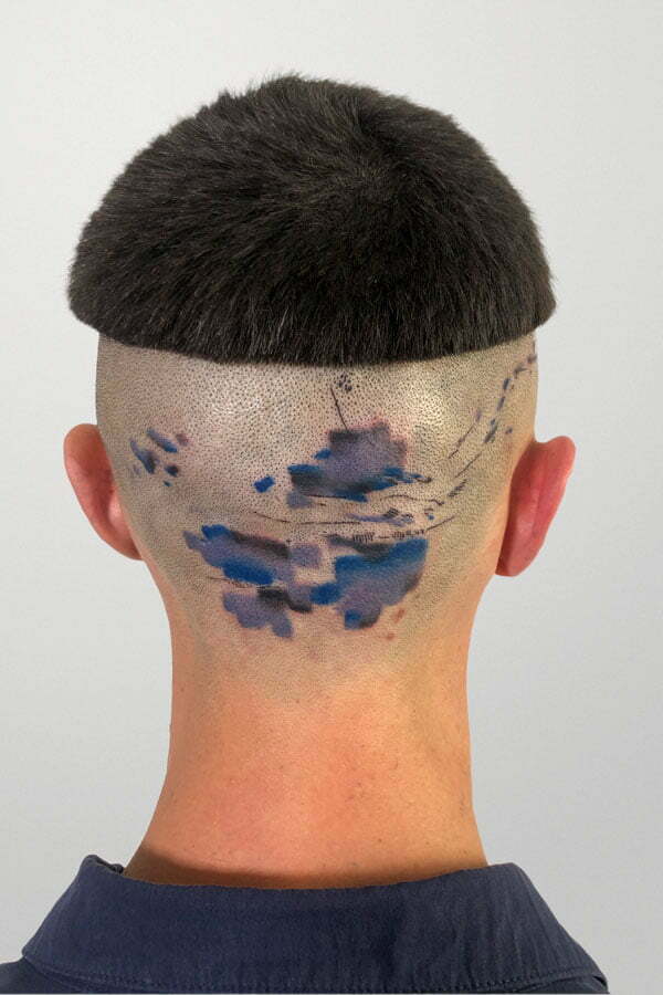 blue abstract cloud tattooed on back of the head