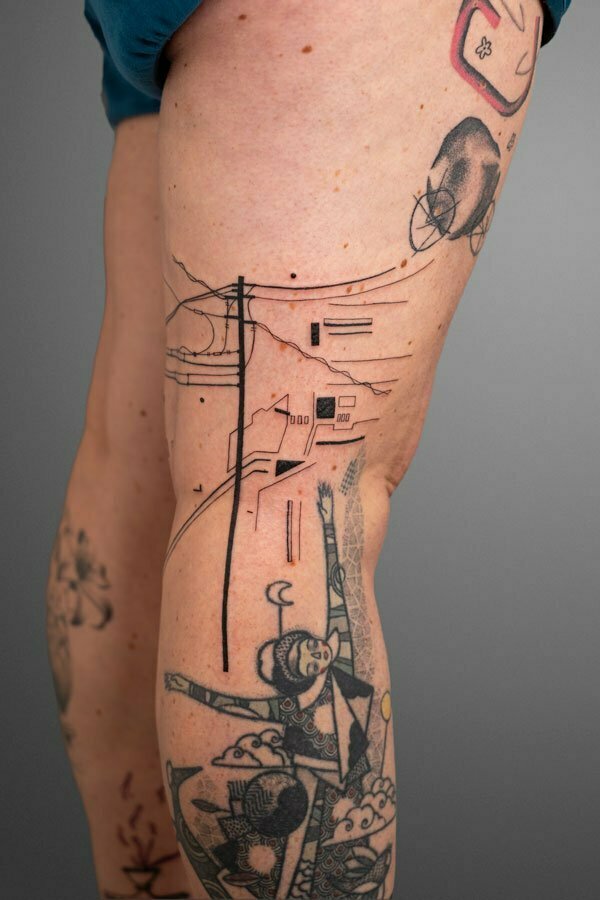 electric cables and architectural elements inked on back of the knee