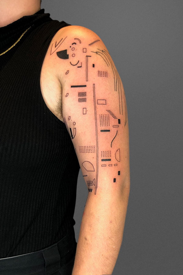 black abstract tattoo composition on shoulder and upper arm