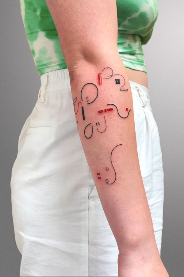 arm tattooed with minimal shapes